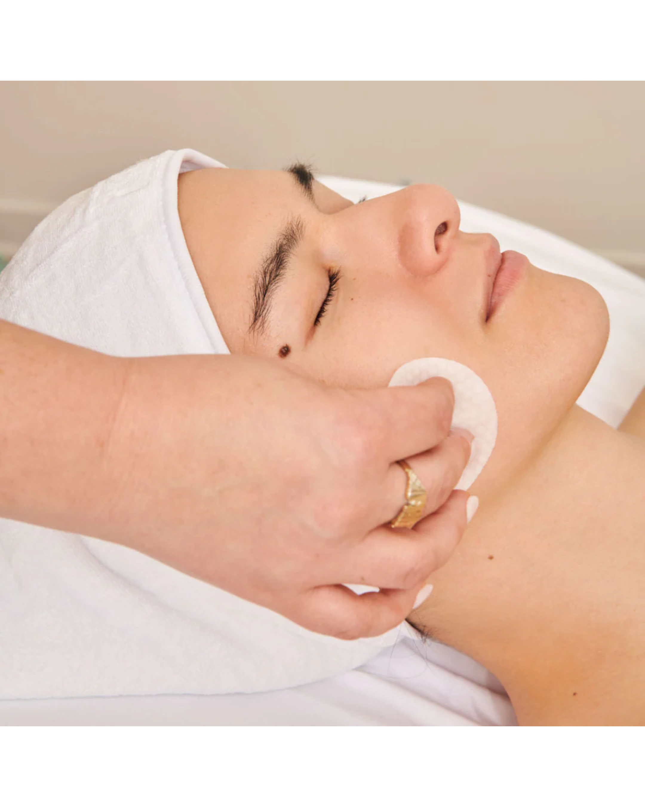 Licensed esthetician in Long Beach performing a gentle exfoliation facial treatment